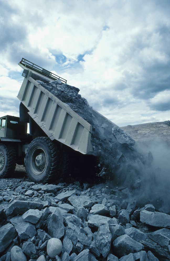Rocks pouring out of dump truck